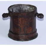 A George III japanned lead tobacco jar, decorated in gilt with a tree, a pipe, ale glass, jug and