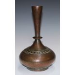 An Indian copper compressed ovoid vase, profusely chased in the Kashmiri taste with stylised lotus