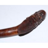 A 19th century Chinese rootwood walking stick, the pommel carved as the head of a sage, his mouth