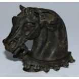 A bronze mount, probably from a sword hilt, cast as the head of a horse, 8.5cm long