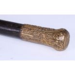 An 18th century gilt metal mounted walking stick, the pommel chased in the Rococo manner with