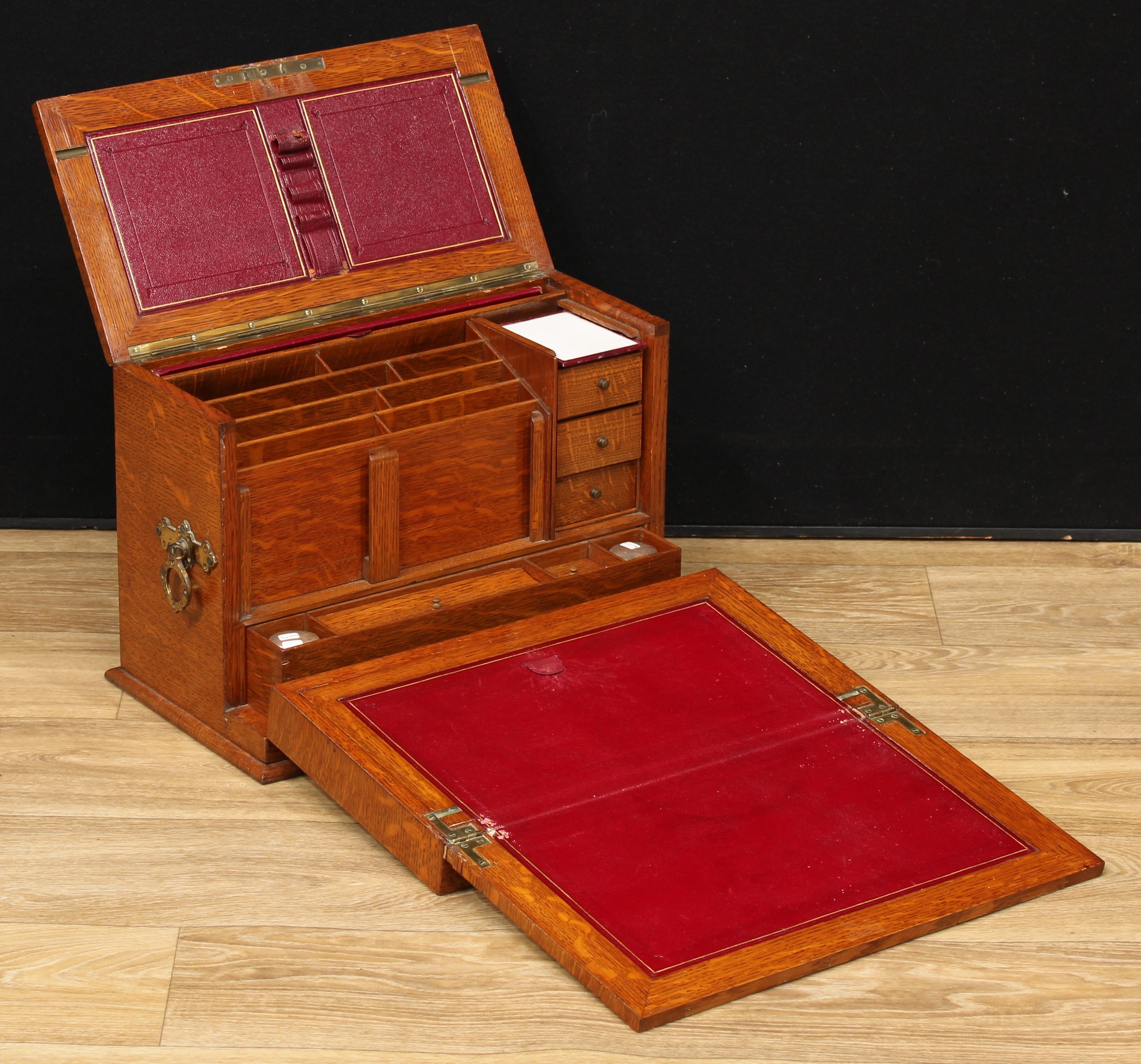A Victorian oak table-top writing and stationery cabinet, hinged cover and fall-front enclosing a