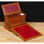 A Victorian oak table-top writing and stationery cabinet, hinged cover and fall-front enclosing a