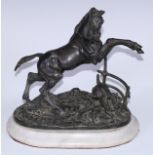 A 19th century animalier group, cast as a horse rearing, startled by a dog, oval alabaster base,