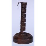 A 19th century wrought iron spiral candlestick, softwood base, 20cm high