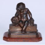 A 19th century French desk momento mori sculpture, cast as a putto contemplating a skull, canted
