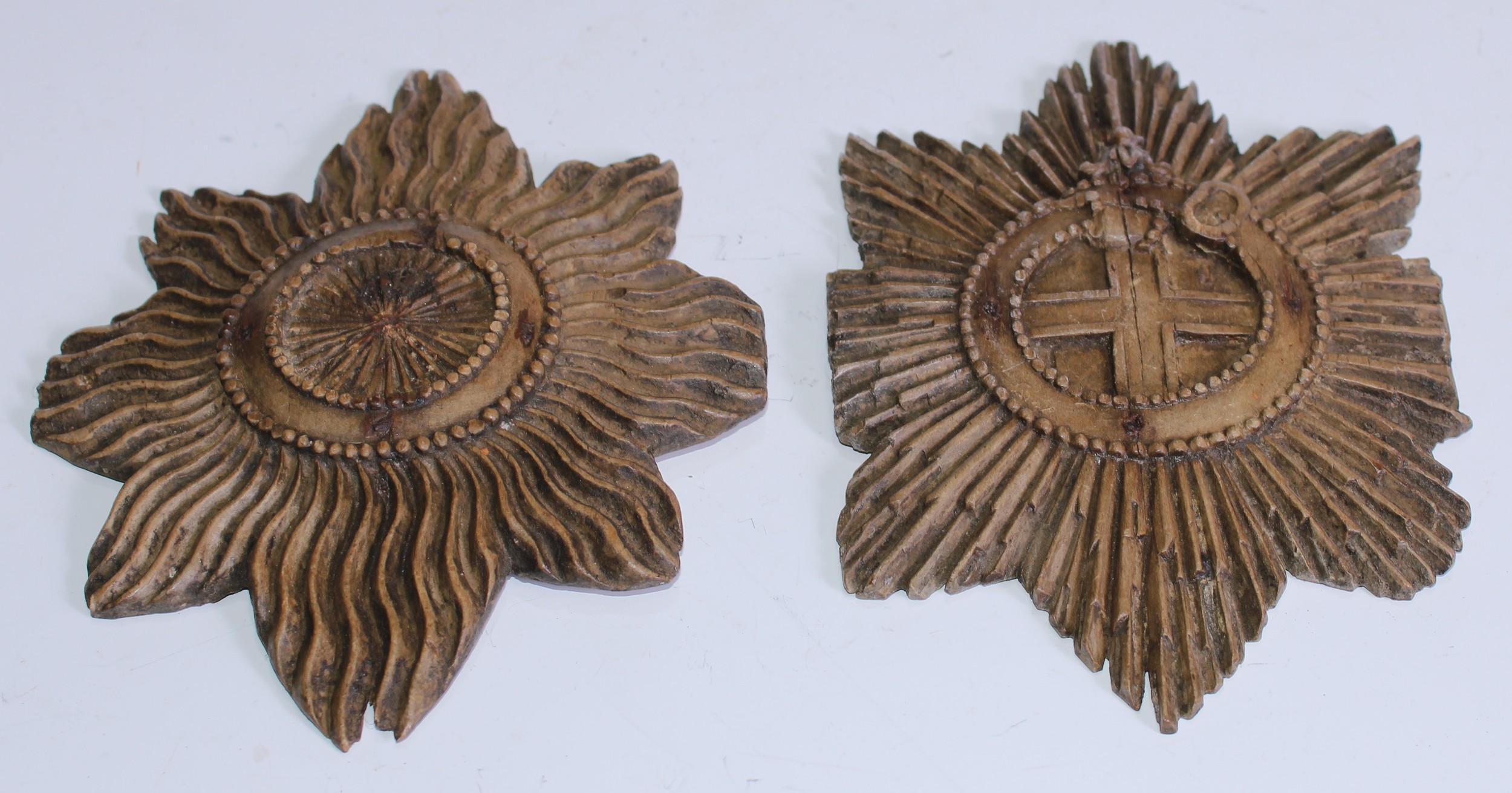 A 19th century carved softwood applique, in relief with garter star, 15.5cm long; another (2)