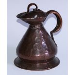 An Arts and Crafts copper water jug, by William Soutter & Sons, of riveted construction, planished