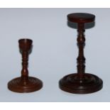 Treen - a 19th century turned fruitwood candlestick, 13cm high; a turned candle stand, 20cm high (2)