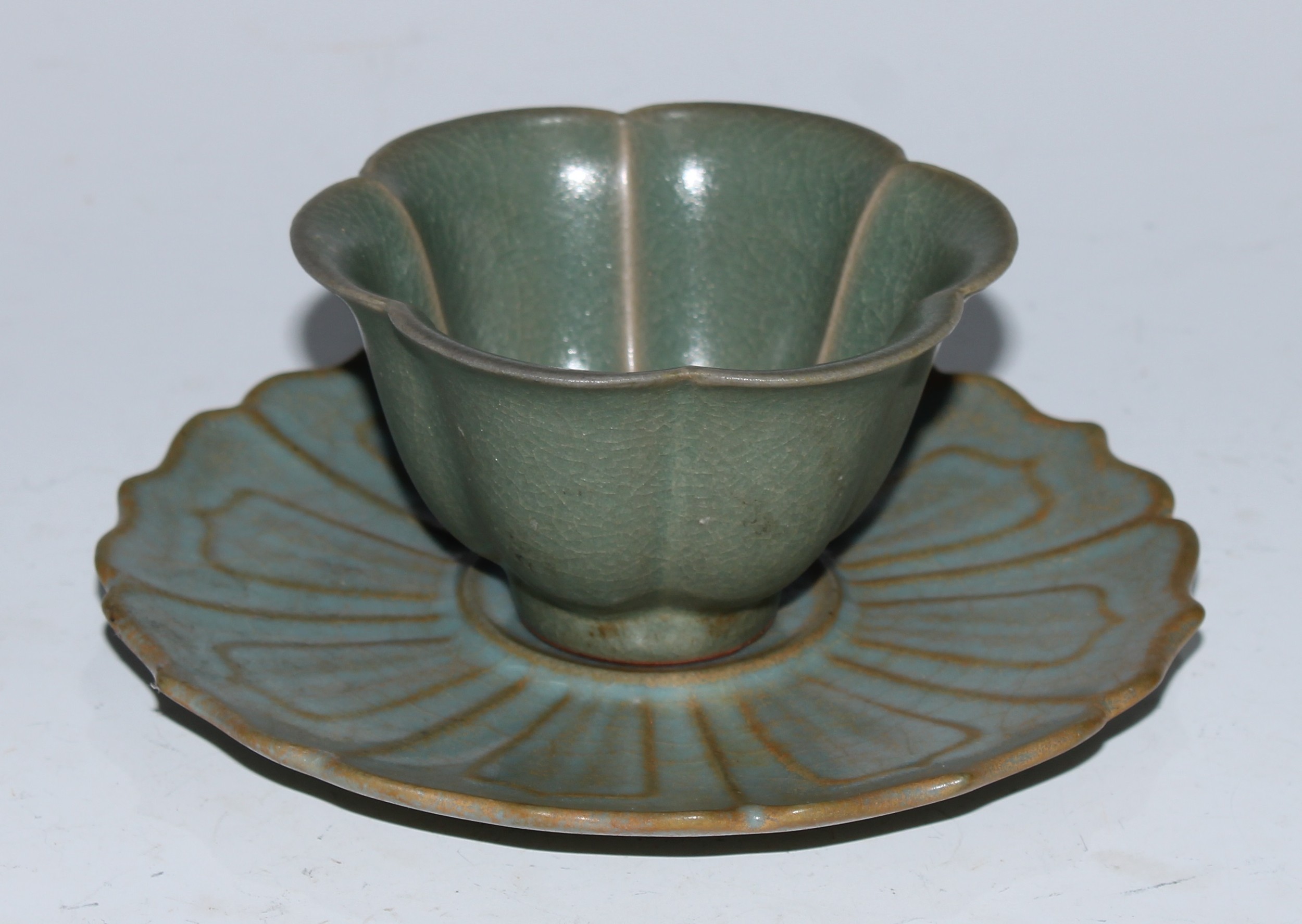 A Chinese celadon lotus wine cup and stand, the saucer 14cm diam