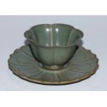 A Chinese celadon lotus wine cup and stand, the saucer 14cm diam