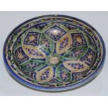 A Middle Eastern earthenware dish, decorated in polychrome in the Persian Islamic taste, 30cm