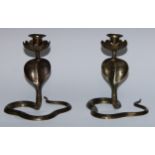 A pair of Indian brass candlesticks, cast as cobras and decorated in the niello manner, 21cm high,