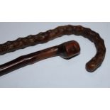 A 19th century country-made novelty walking cane, the pommel carved with a face, 84cm long;