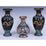 A pair of Chinese cloisonne enamel ovoid vases, decorated in the famille noir palette with dragons