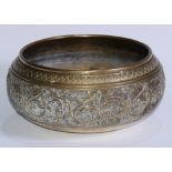 A 19th century Indian/Ceylonese bronze singing bowl, cast with scrolling leafy stems and a band of