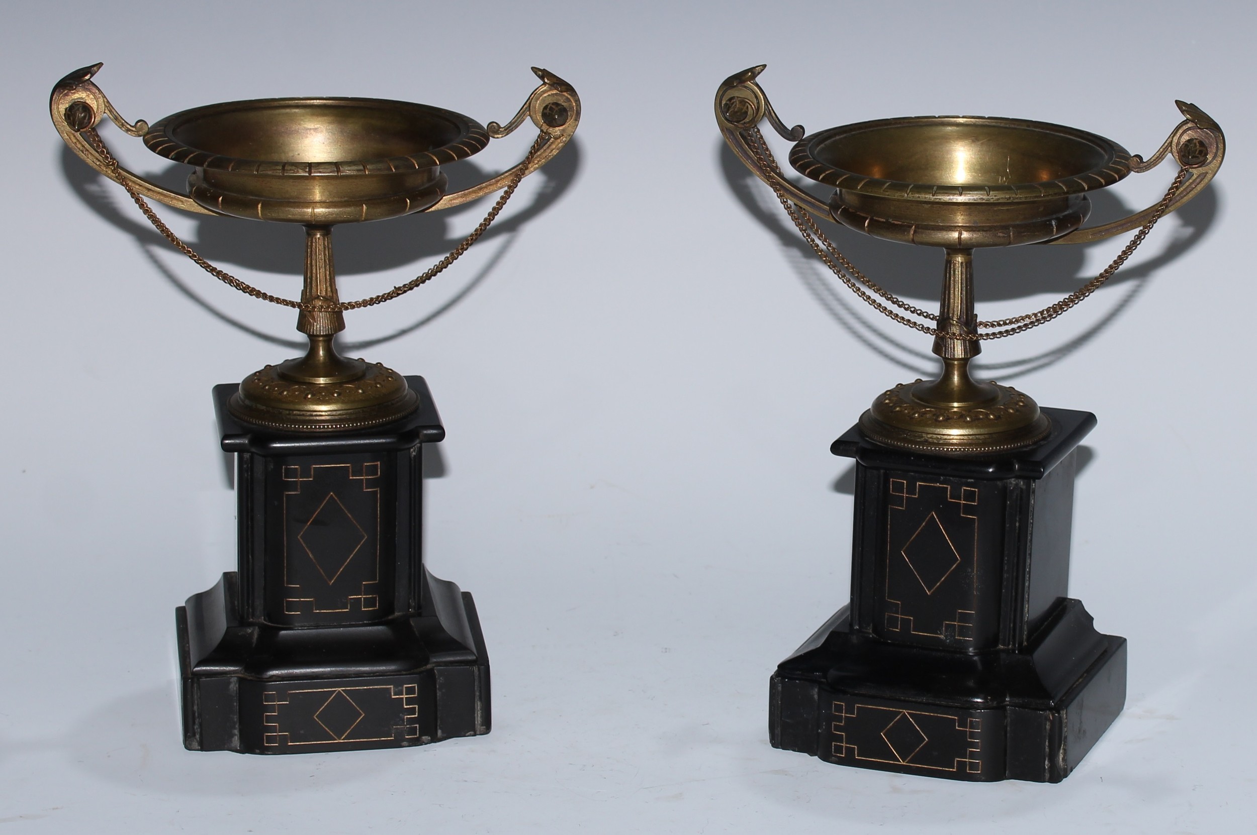 A pair of 19th century brass saucer shaped pedestal mantel tazzas, acanthus scroll handles,