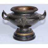 A 19th century brown patinated bronze pedestal urn, cast and applied with a mask, egg-and-dart