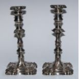 A pair of 19th century Old Sheffield Plate candlesticks, of George II design, shells to angles,