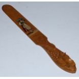 A Swiss softwood page turner, carved in the Black Forest manner with fruiting vine, the blade