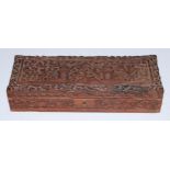 An Indian hardwood rectangular box, profusely carved in relief with temple buildings, scrolling