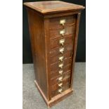 A Late Victorian Mahogany Wellington Chest, shaped cornice over ten short drawers, 126cm tall x 46cm