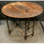 A 19th century 17th century style oak drop-leaf table, oval carved top, bobbing turned supports,
