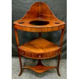 A George III mahogany, bow-front, corner wash stand, arched backsplash, three tiers with small