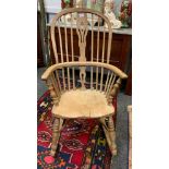 A country house Elm and Ash rocking chair, pierced splat, saddle seat, turned legs, X-stretcher.