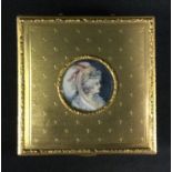 A 20th century gilt metal trinket box, embossed floral body, inset with a portrait miniature of a