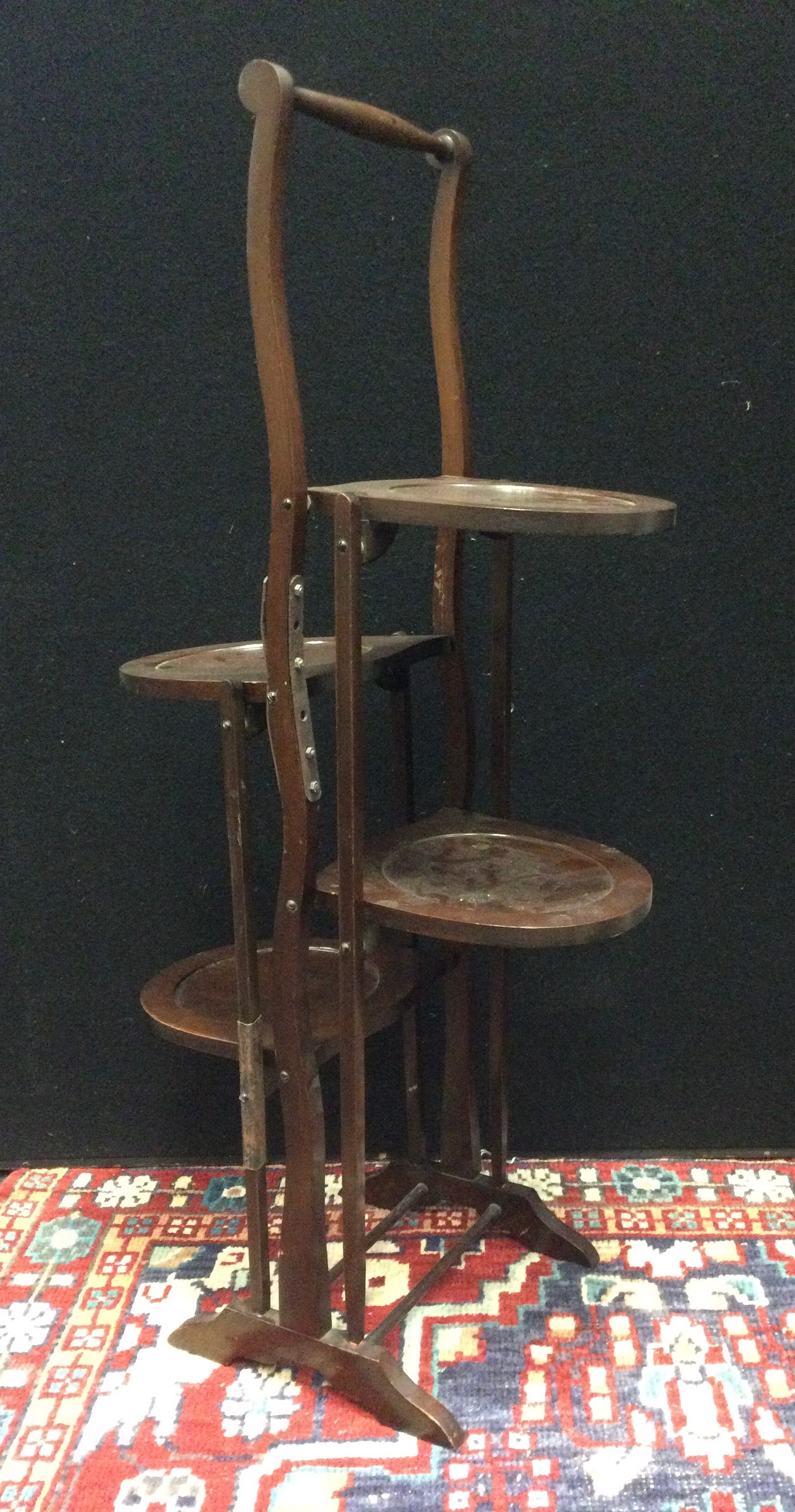 An early 20th century, four tier, collapsible mahogany cake stand, c.1920