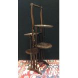 An early 20th century, four tier, collapsible mahogany cake stand, c.1920