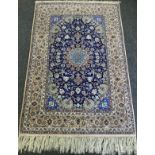A Persian Isfahan Rug, the fine, short wool pile and silk carpet woven in shades of deep blue,
