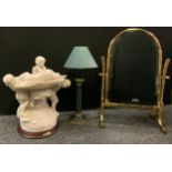 A modern brass bamboo effect dressing mirror, 64cm high; a resin marble effect figural lamp, Chou