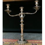 A large 19th century silverplated table stick, twin scrolling arms, sectional ornate column, grape