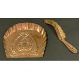 An Art Nouveau hand hammered copper crumb tray and brush, embossed with three tulips and tied ribbon