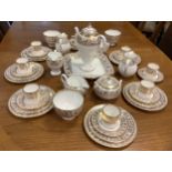 A Wedgwood Gold Florentine pattern table service inc coffee pot, seven coffee cans, milk and cream
