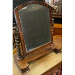 An early Victorian mahogany toilet mirror, having an arch-top mirror with barley-twist supports on a