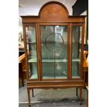 An Edwardian mahogany display cabinet, central inlaid dome top above a glazed door inclosing
