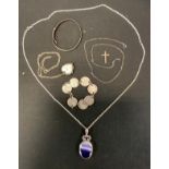 A silver mounted oval pendant, set with an amethyst; a silver heart locket; silver child's bangle;