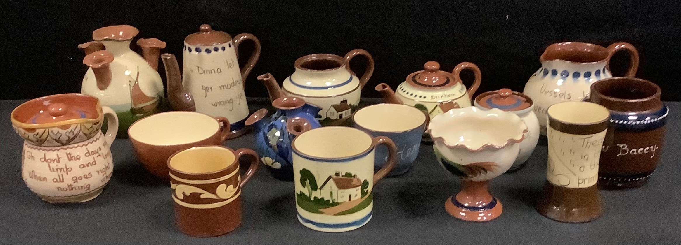 Torquay ware and Devon ware pottery; a small teapot, decorated with a country cottage in 'Brixham'