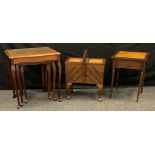 A 20th century mahogany nest of three leather-top tables, shaped rectangular tops, cabriole legs;
