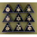A consecutive set of nine Swarovski crystal glass Christmas star baubles, 2003-2011, each triangular