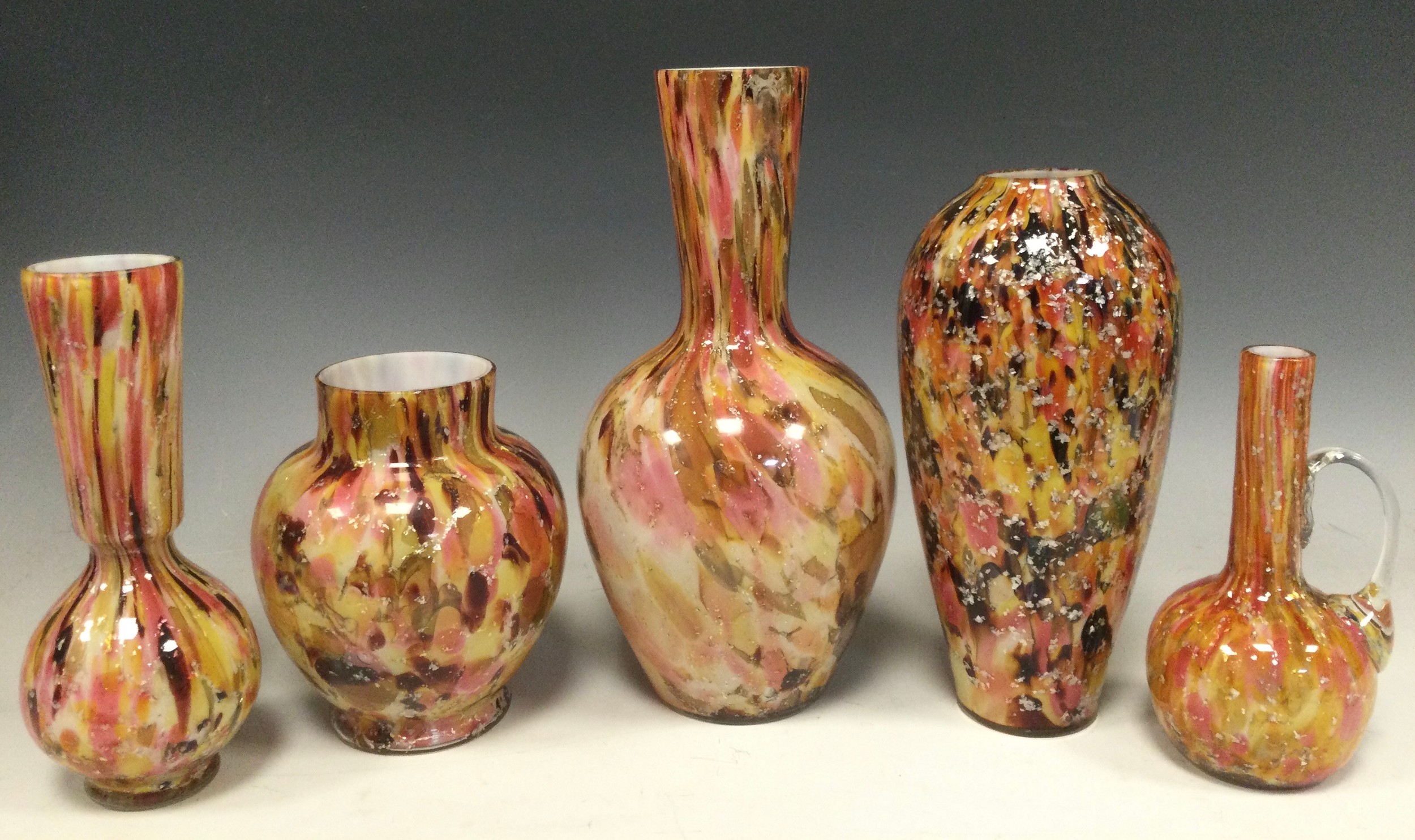 Studio Glass; a group of five Murano type glass vases, each with encased swirls of autumnal colour