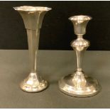 A George V silver candlestick, weighted base, Birmingham 1916; a bud vase, weighted base,