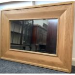 A Contemporary Oak Over-Mantel Mirror, broad, rounded rectangular frame, bevelled mirror, 80cm x