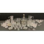 An early 20th century cut glass water set, jug and six glasses; others jugs, whisky tumblers,