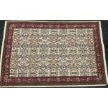 A Turkish woollen rug, the field with stylised foliage, in tones of pink, green and blue adn a cream