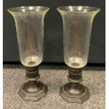 A pair of 19th century candle lamps, cast metal octagonal base, spreading stepped foot, clear