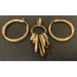 A diamond 9ct gold multi hoop pendant, stamped 375, 0.11; a pair of similar hoop earrings, 8g gross